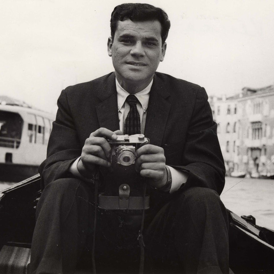 Martin Rodbell holding a camera