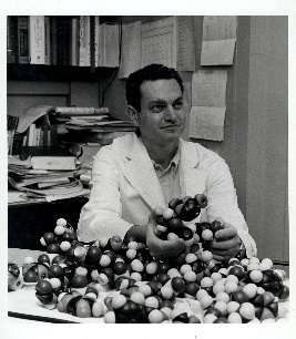 Photo of scientist working with molecular model
