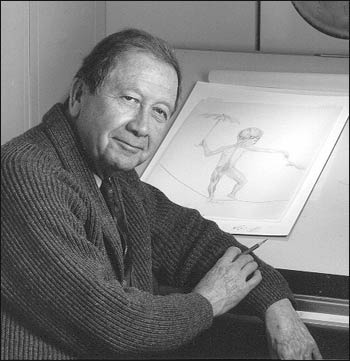 Photograph of Howard Bartner in front of his drawing board