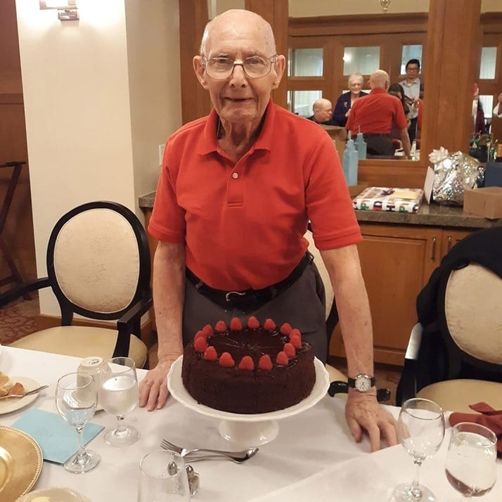 Happy older man with birthday cake