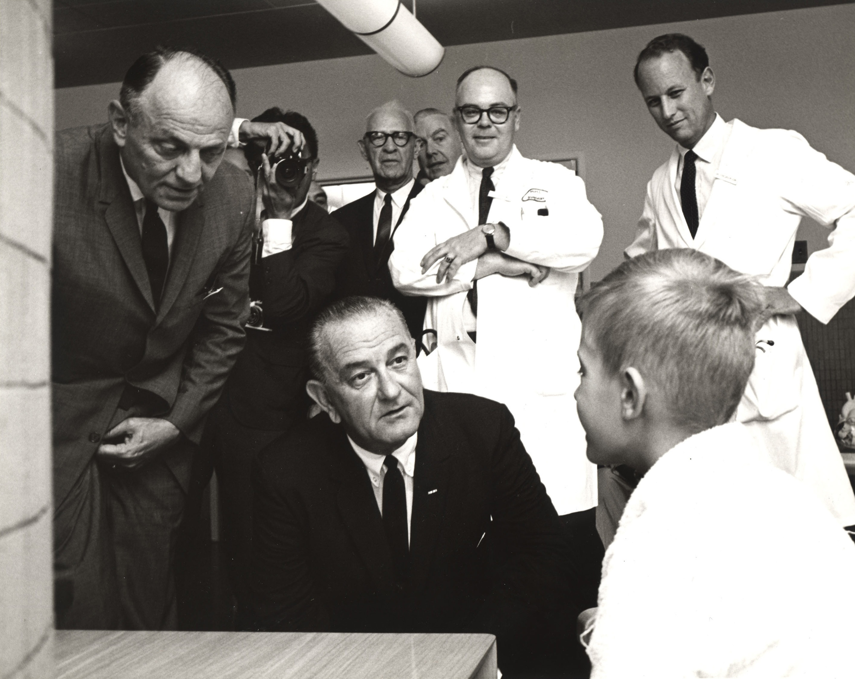 President Johnson and Dr. Morrow speak with young patient