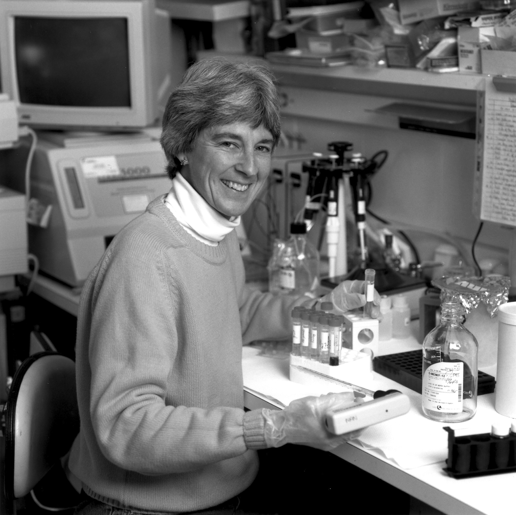 Anita B. Roberts sitting at a laboratory bench.
