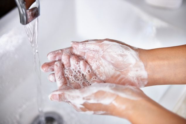 photograph of someone washing their hands with soap