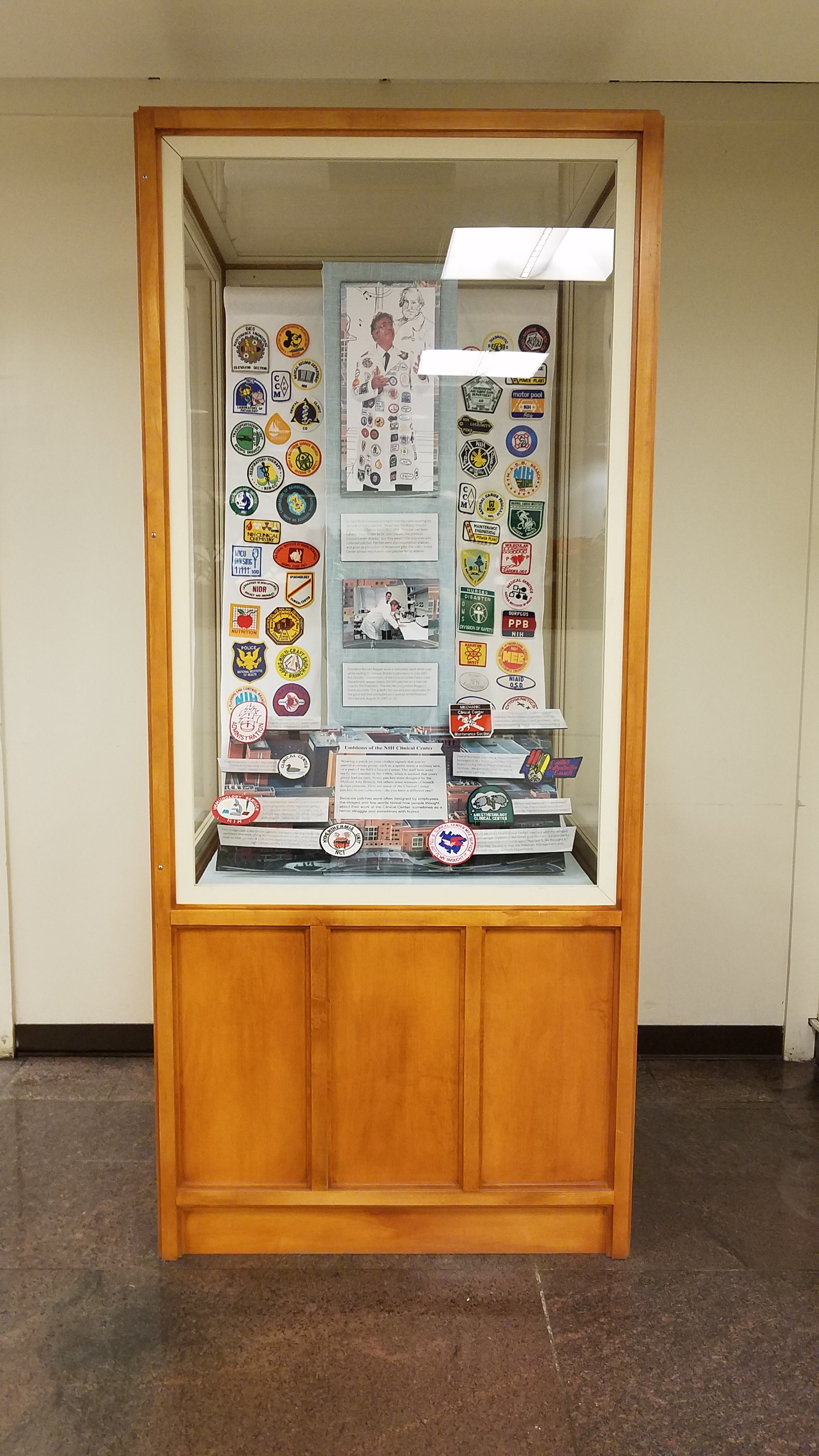 Photo of display case showing a variety of Clinical Center patches near the Hospitality Desk on the 1st floor of the Clinical Center