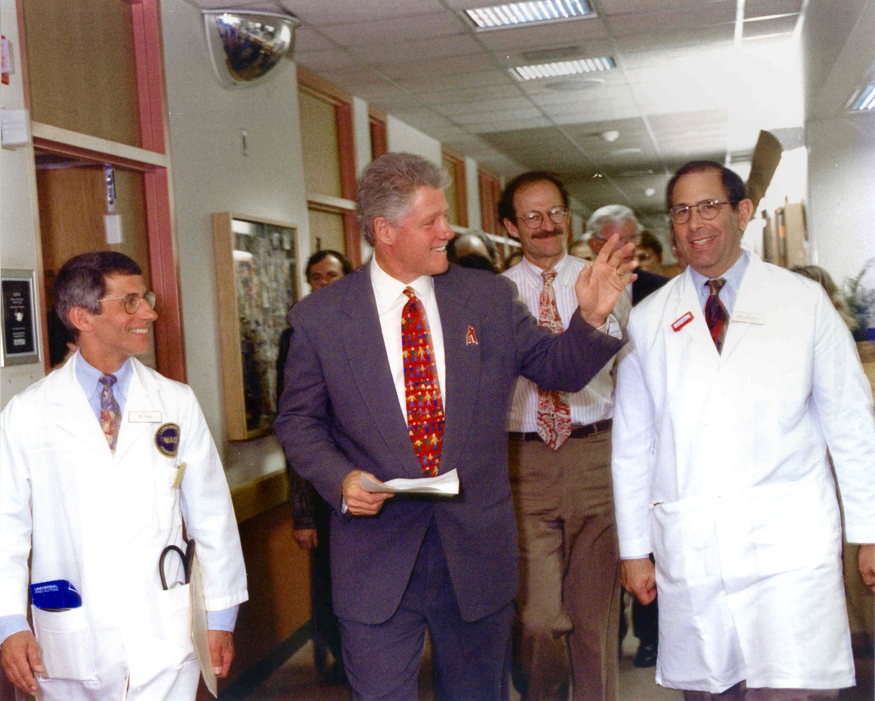 Photo 5.  President Clinton on Rounds in the NIH Clinical Center, August 5, 1995.  (left to right Dr. Anthony S. Fauci, President Clinton, Dr. Harold Varmus, Dr. John Gallin)