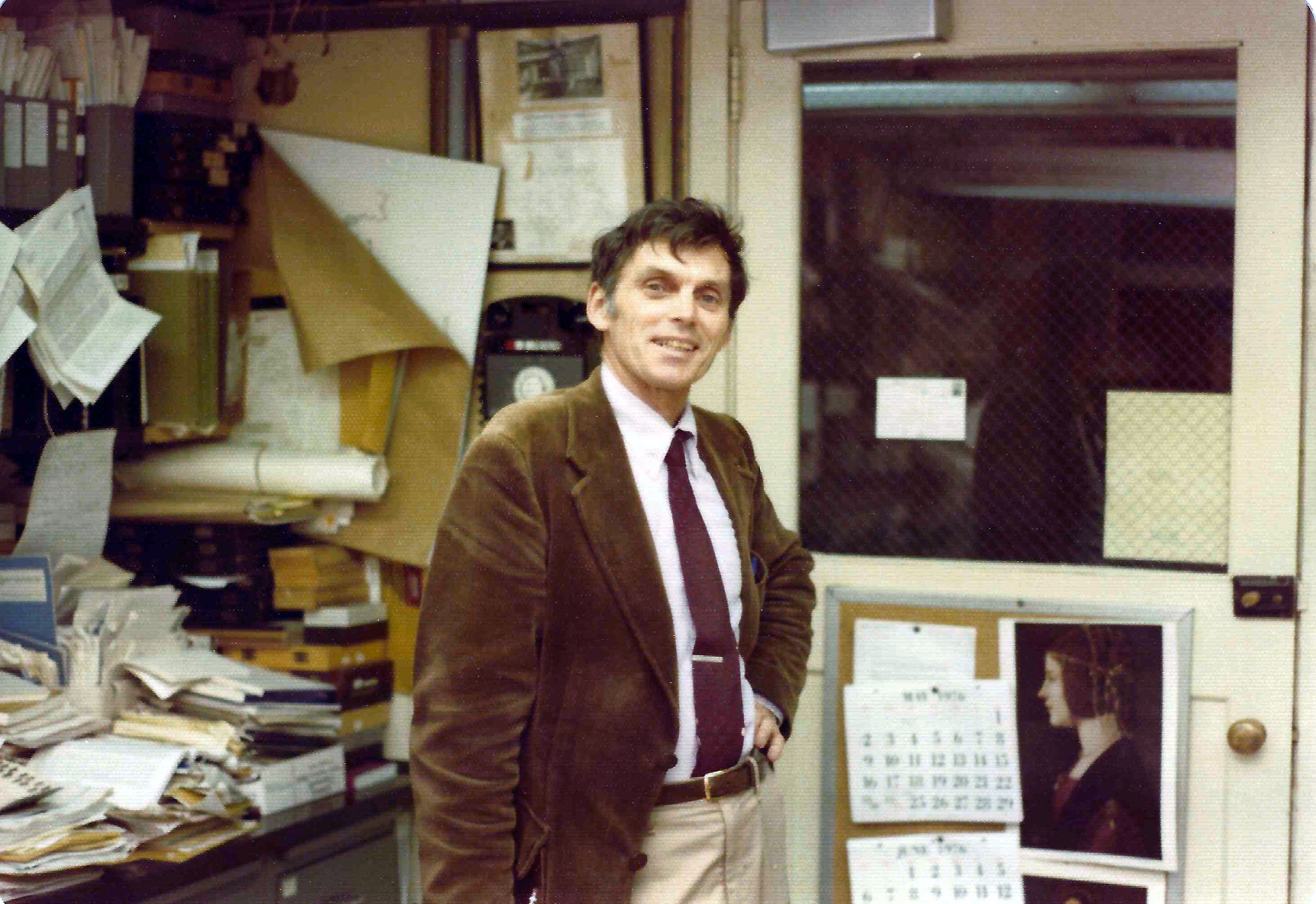 Dr Potter standing in his laboratory smiling at the camera