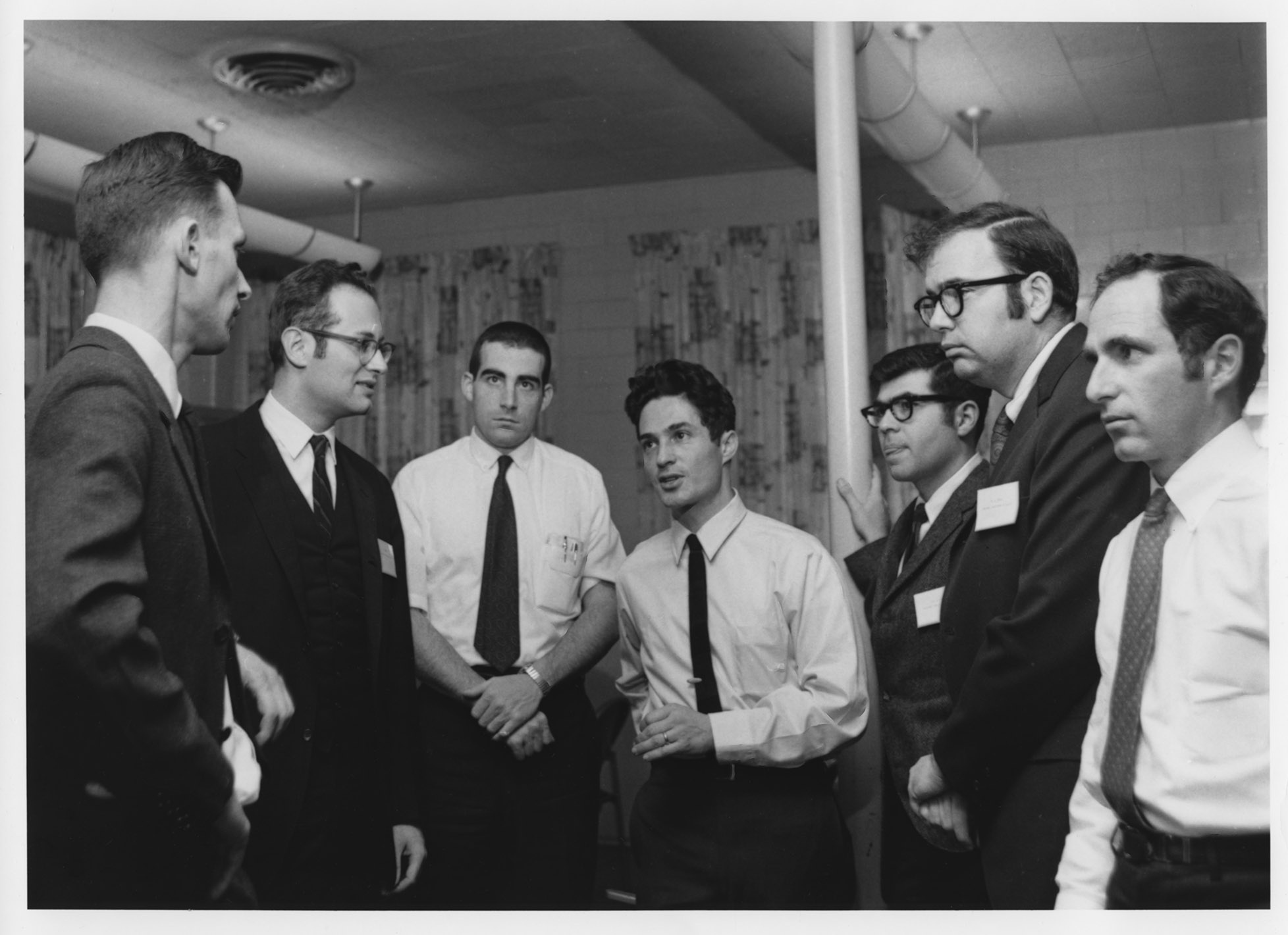 Group of men standing, having a discussion