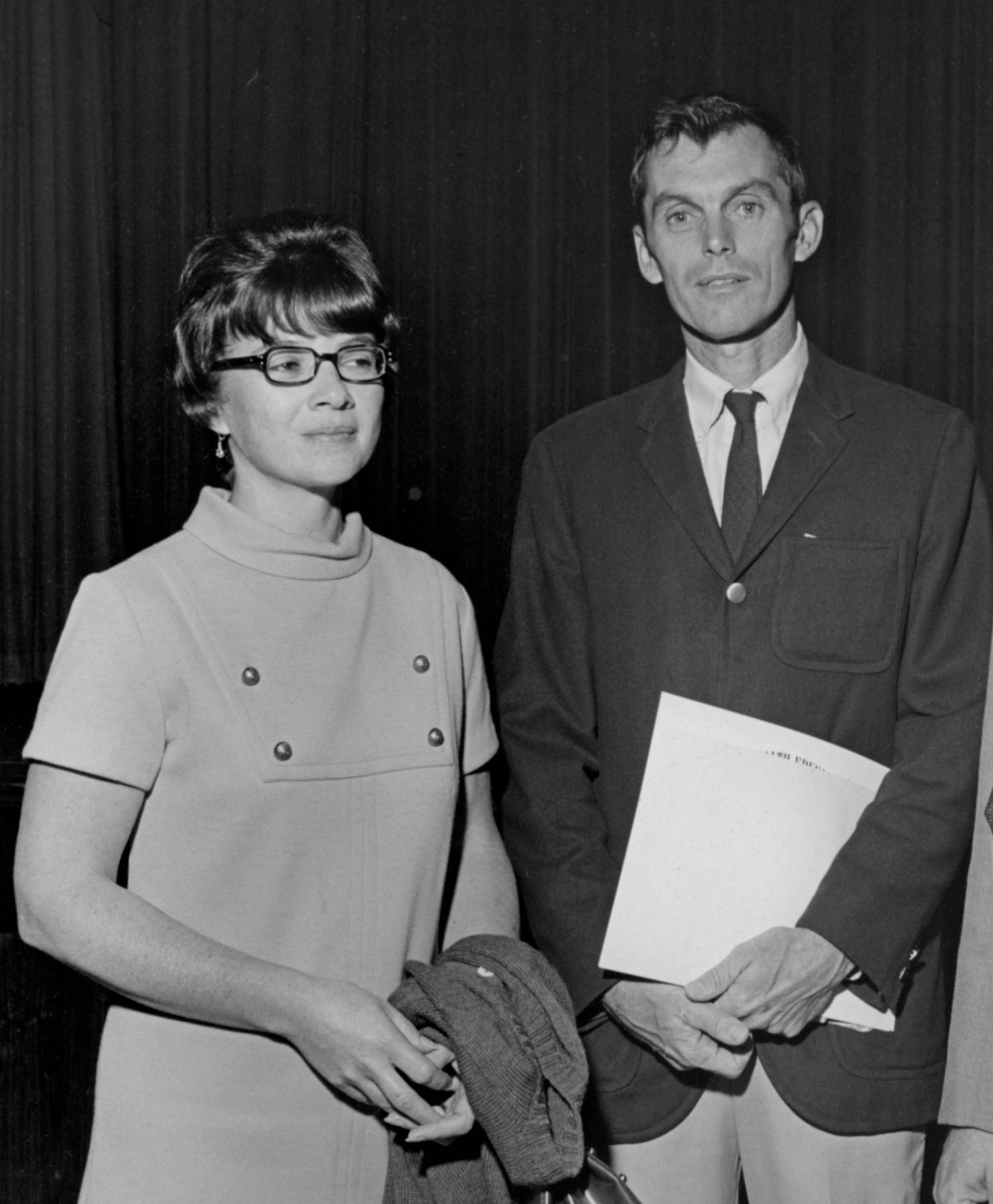 Dr. Potter holding award, standing next to his wife