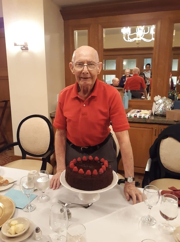 Happy older man with birthday cake