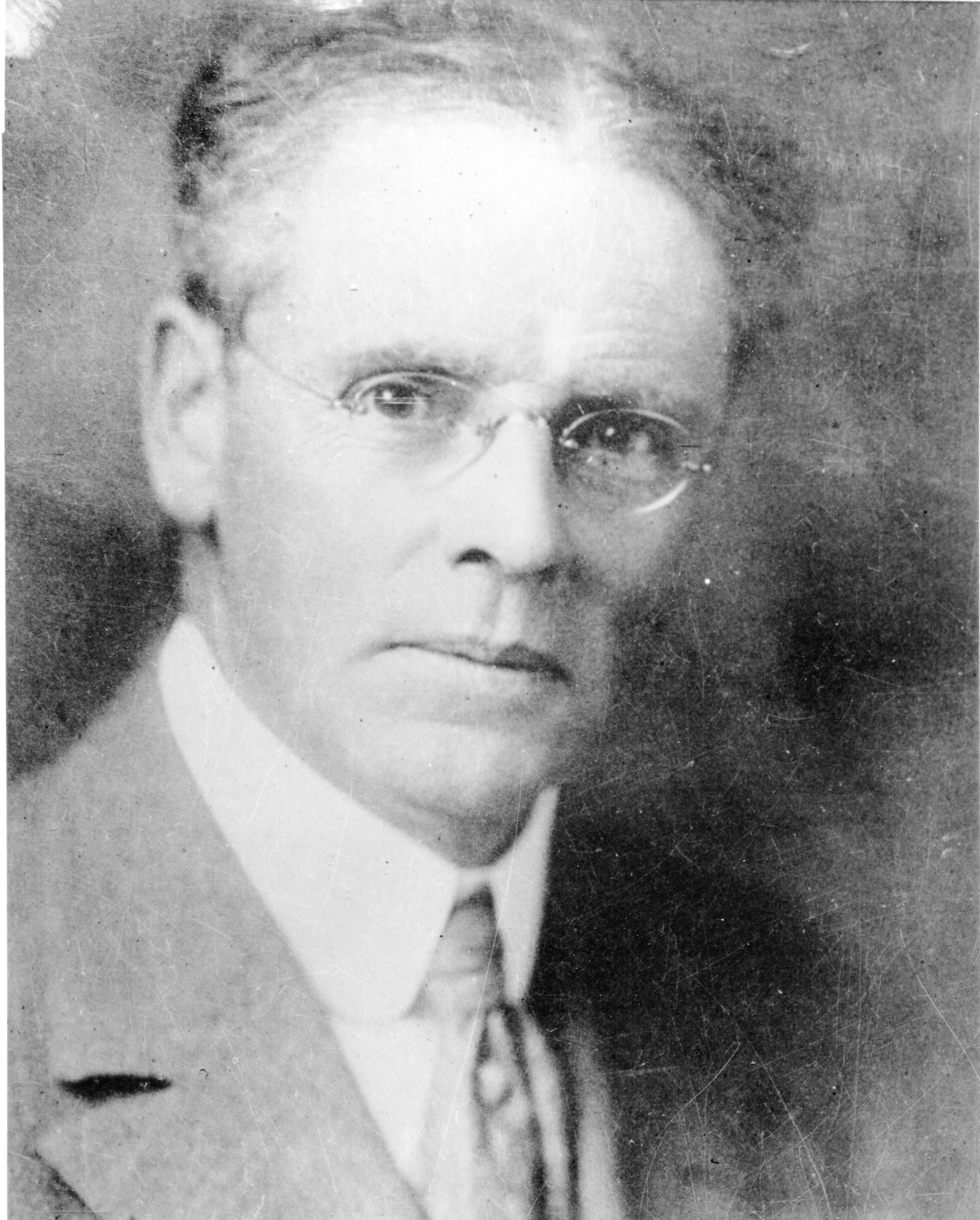 Portrait of stern man in wire frame glasses