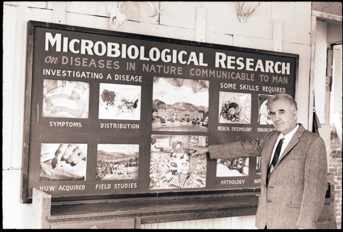 Man pointing to Microbiological Research display