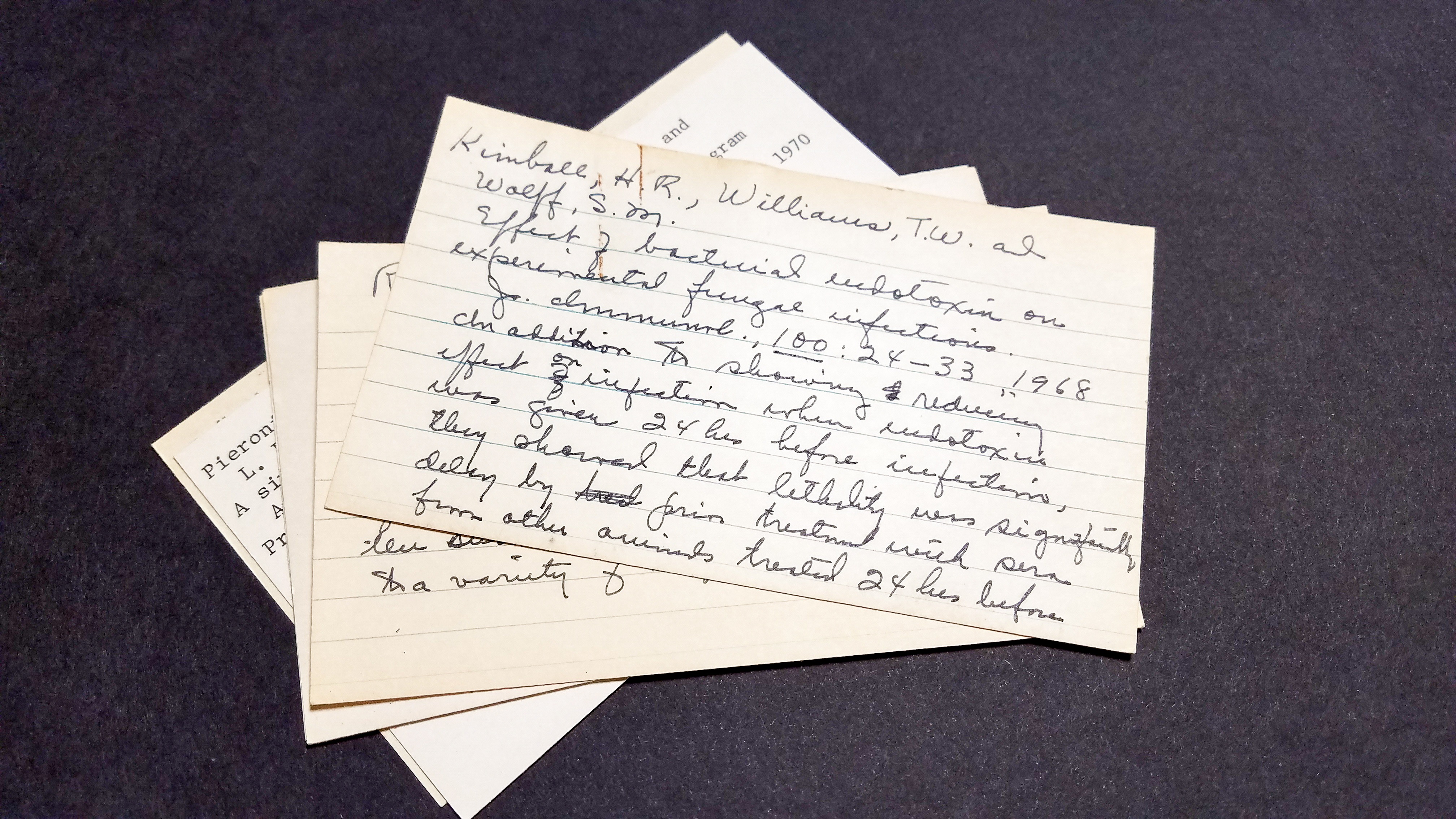 a photo of handwritten notecards that belonged to Dr. Margaret Pittman and have summaries of scientific papers on them
