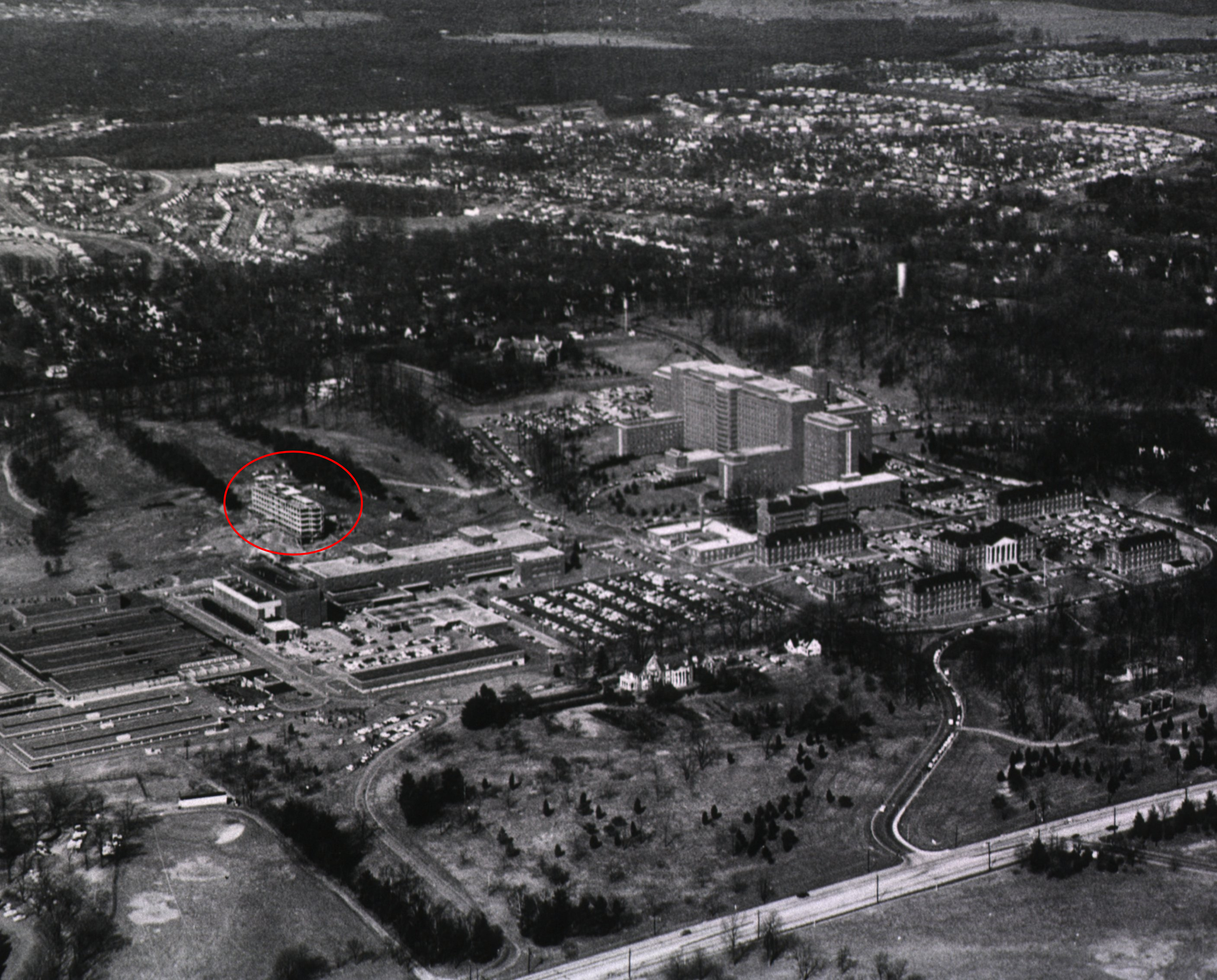 a circa 1960 aerial photo of NIH Bethesda campus with building 29 under construction circled