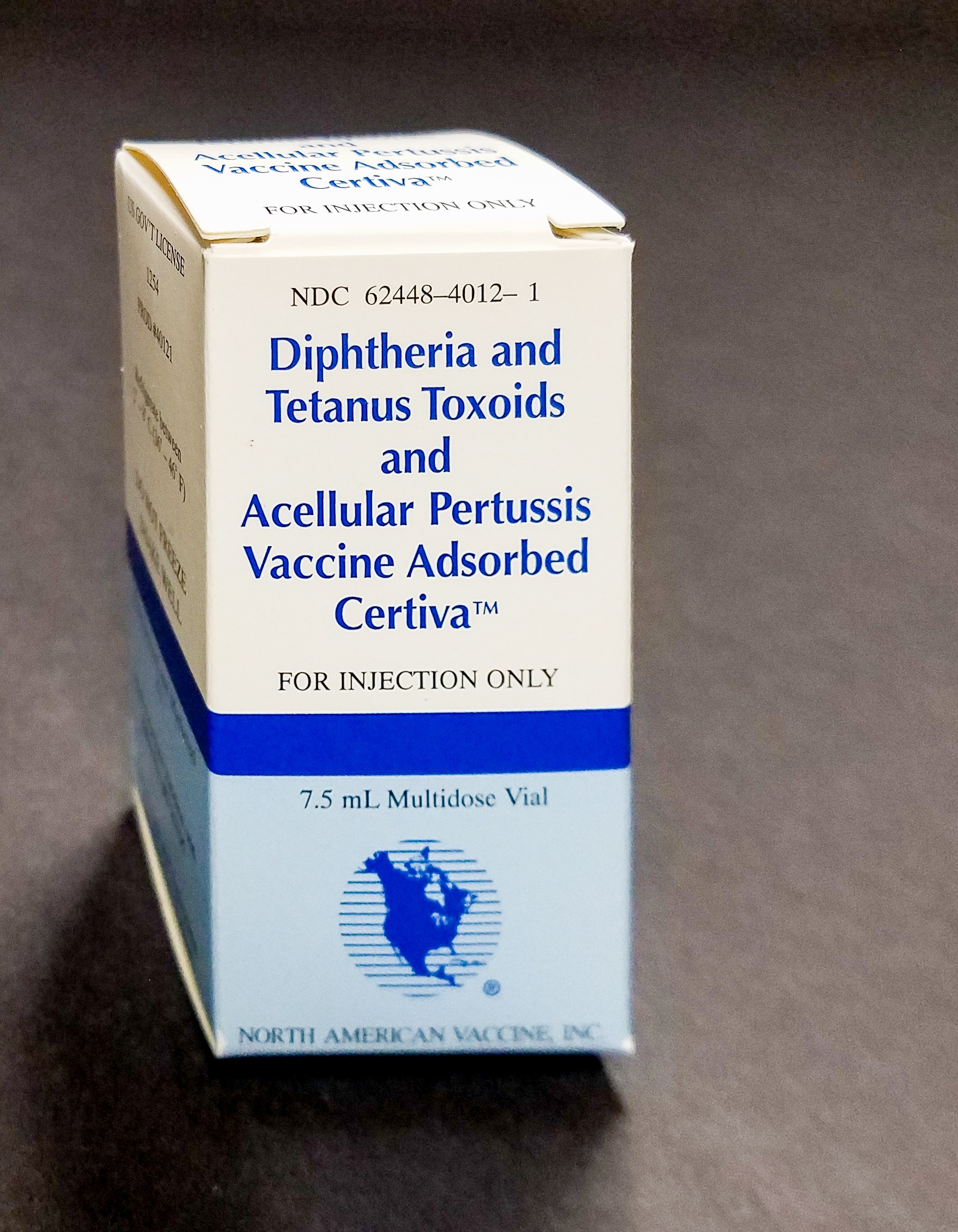 a box with a vial of North American Vaccine, Inc. Diphtheria and Tetanus Toxoids and Acellular Pertussis Vaccine from 1990s. 