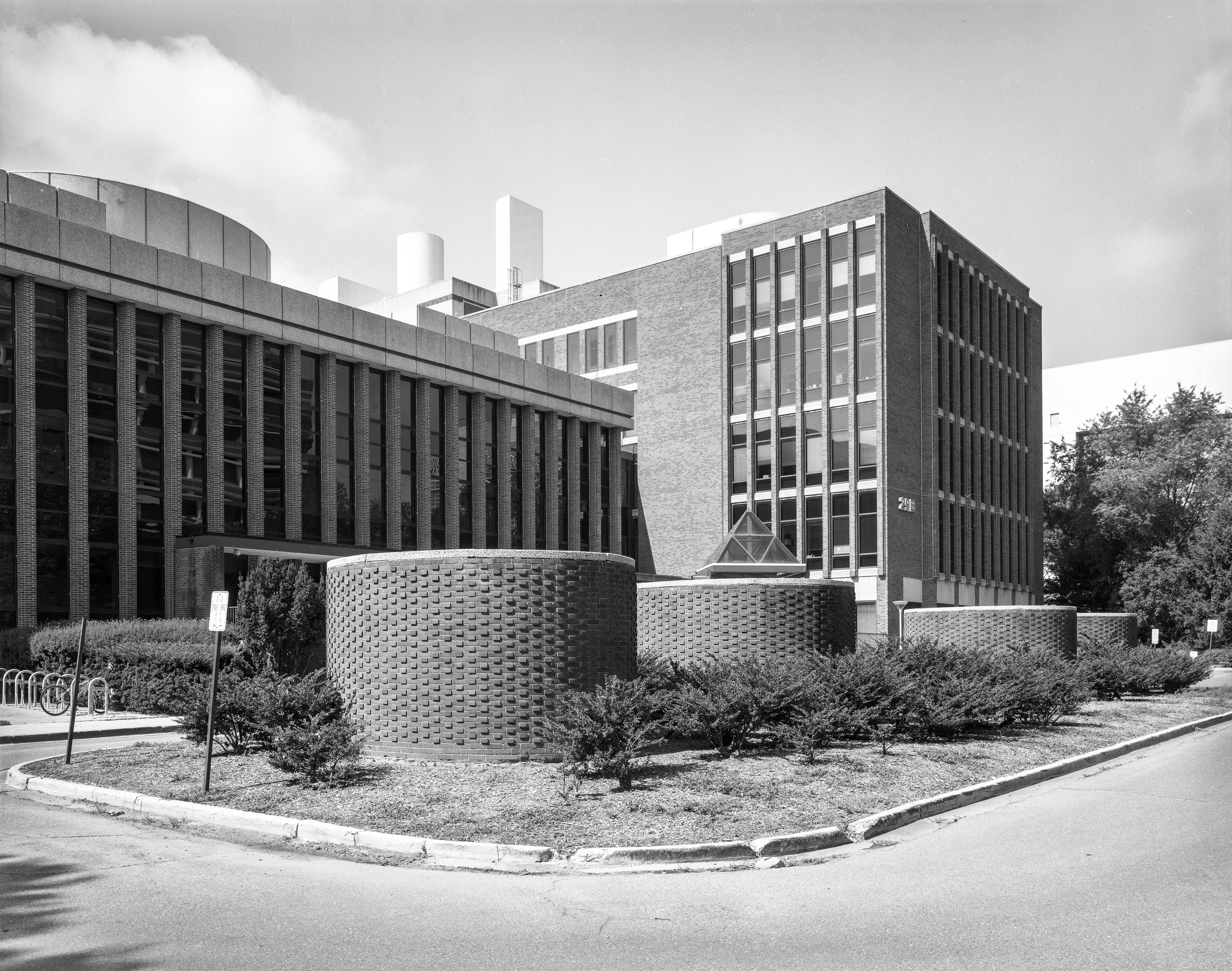 Air intake towers in center median in front of Building 29A, with Building 29B in the background in a HABS photo taken July 2021.