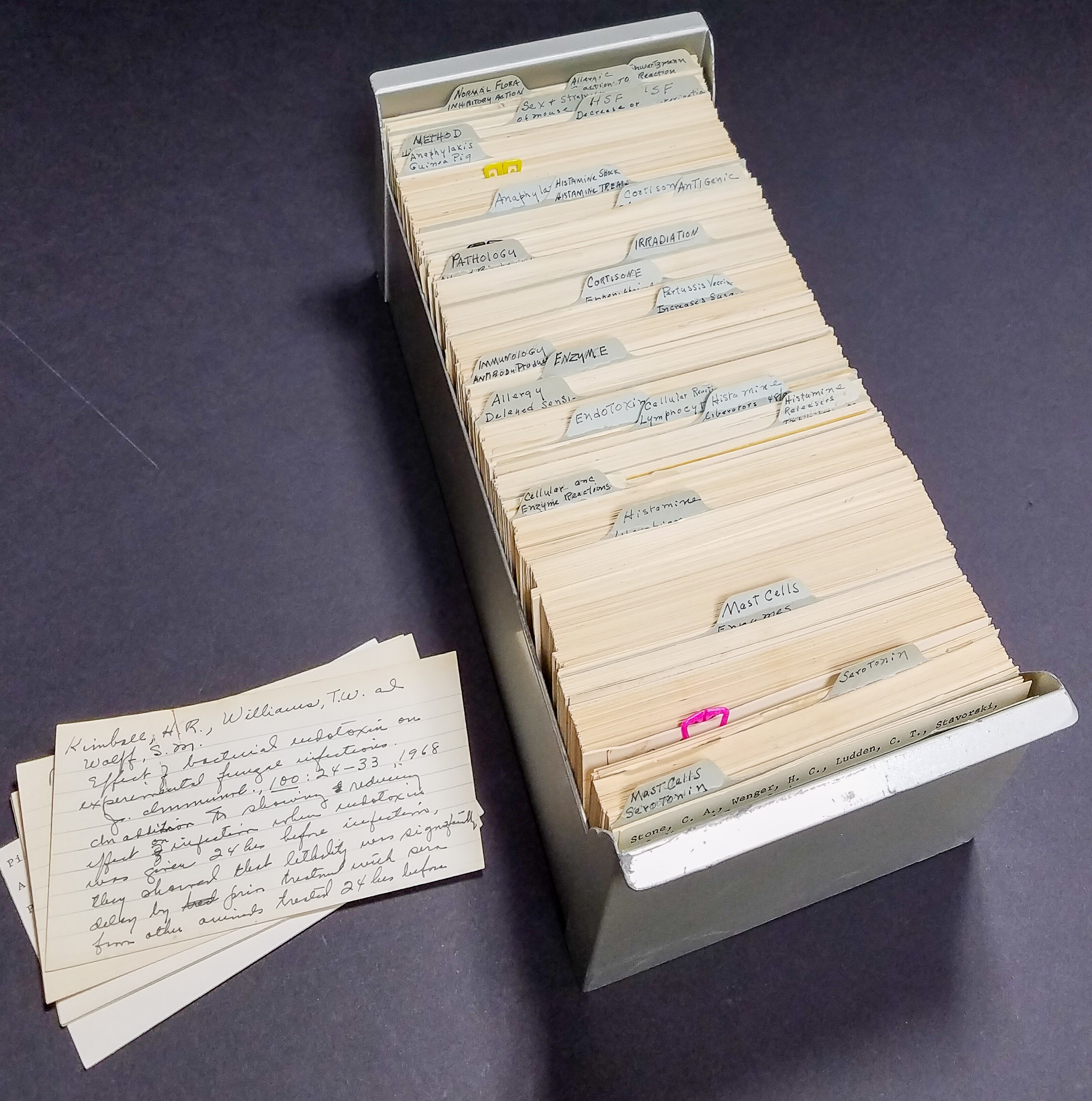 a rolodex of notecards with handwritten summaries of scientific papers, organized by topic, belonging to Margaret Pittman