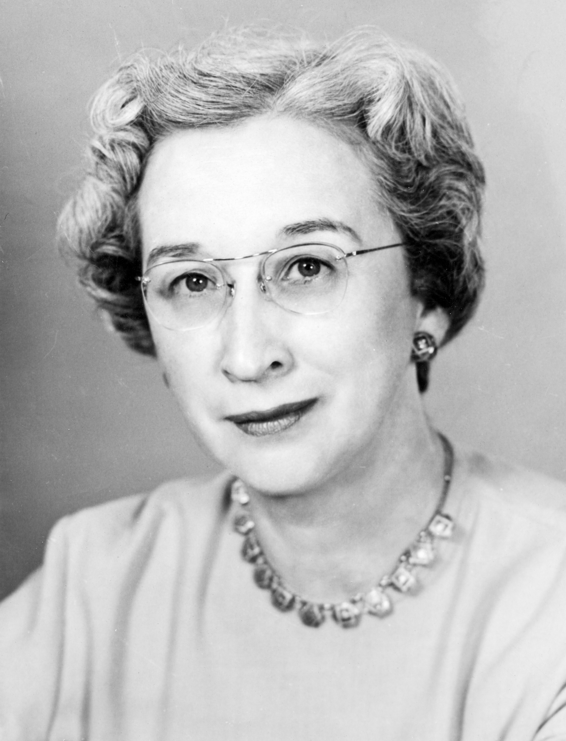 Professional photograph of Dr. Sarah Stewart wearing glasses and pearls
