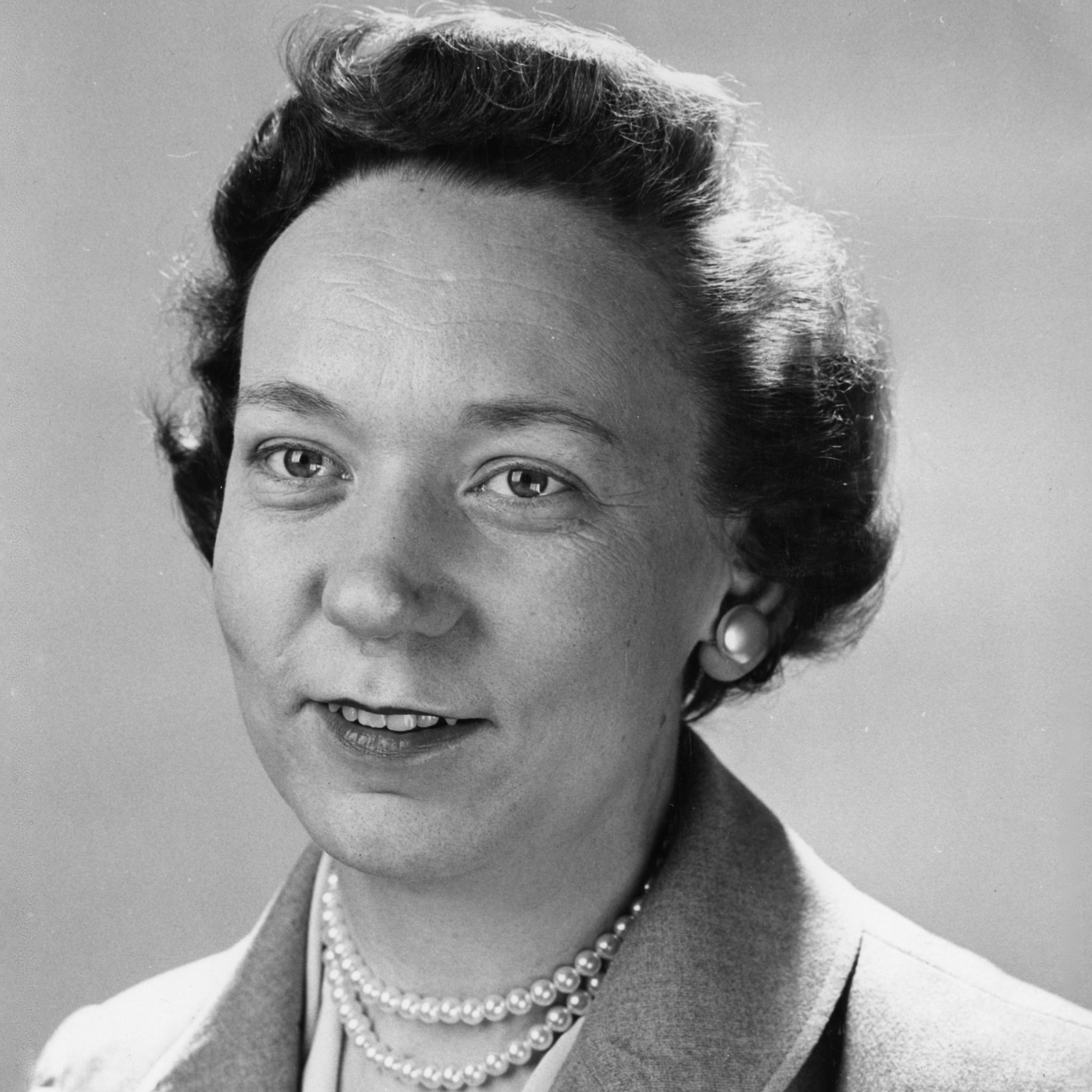 Professional photo of Madge Crouch in a suit with a pearl necklace