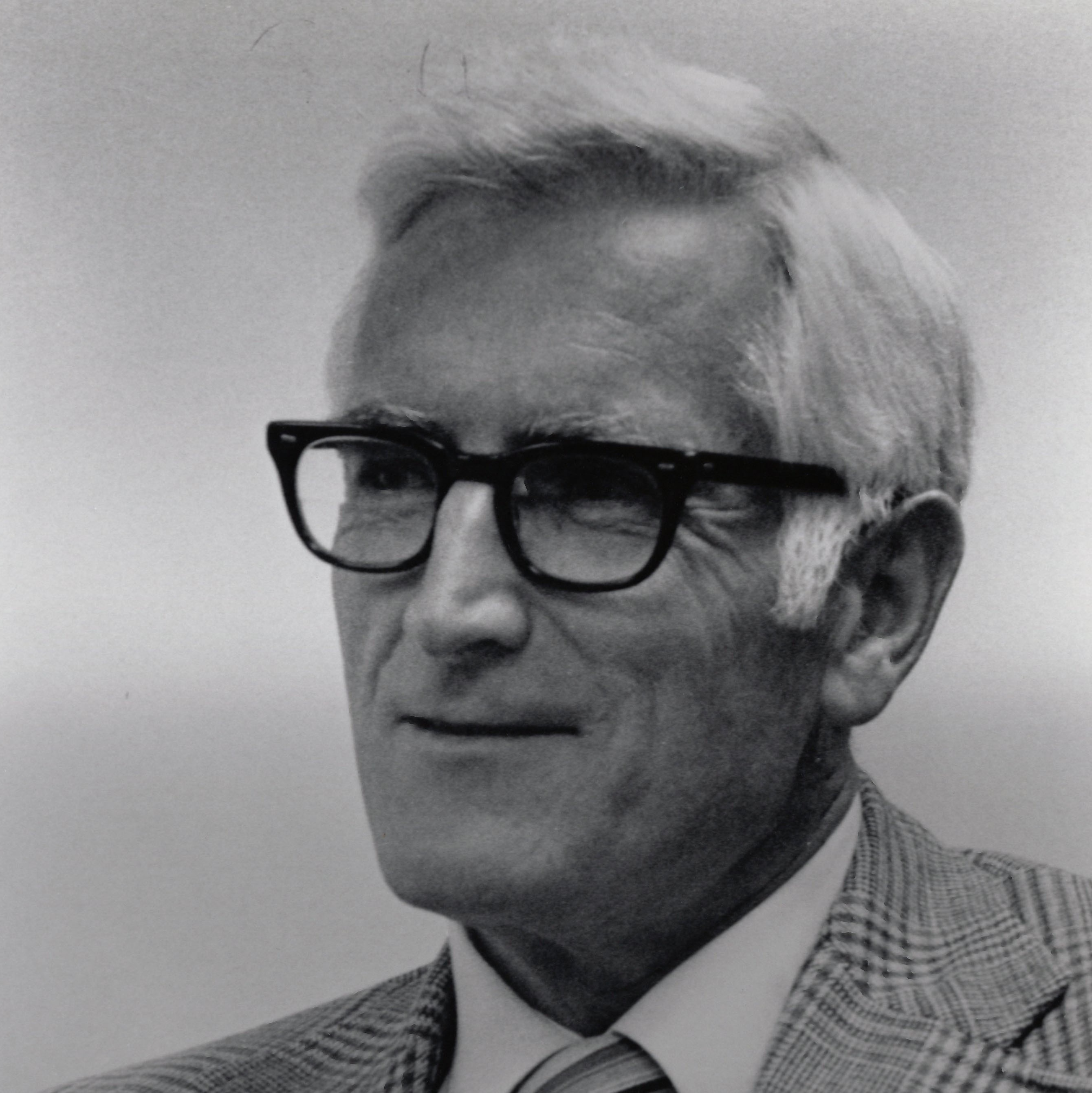 Professional photo of Harry M. Meyer Jr. in a suit with black glasses on
