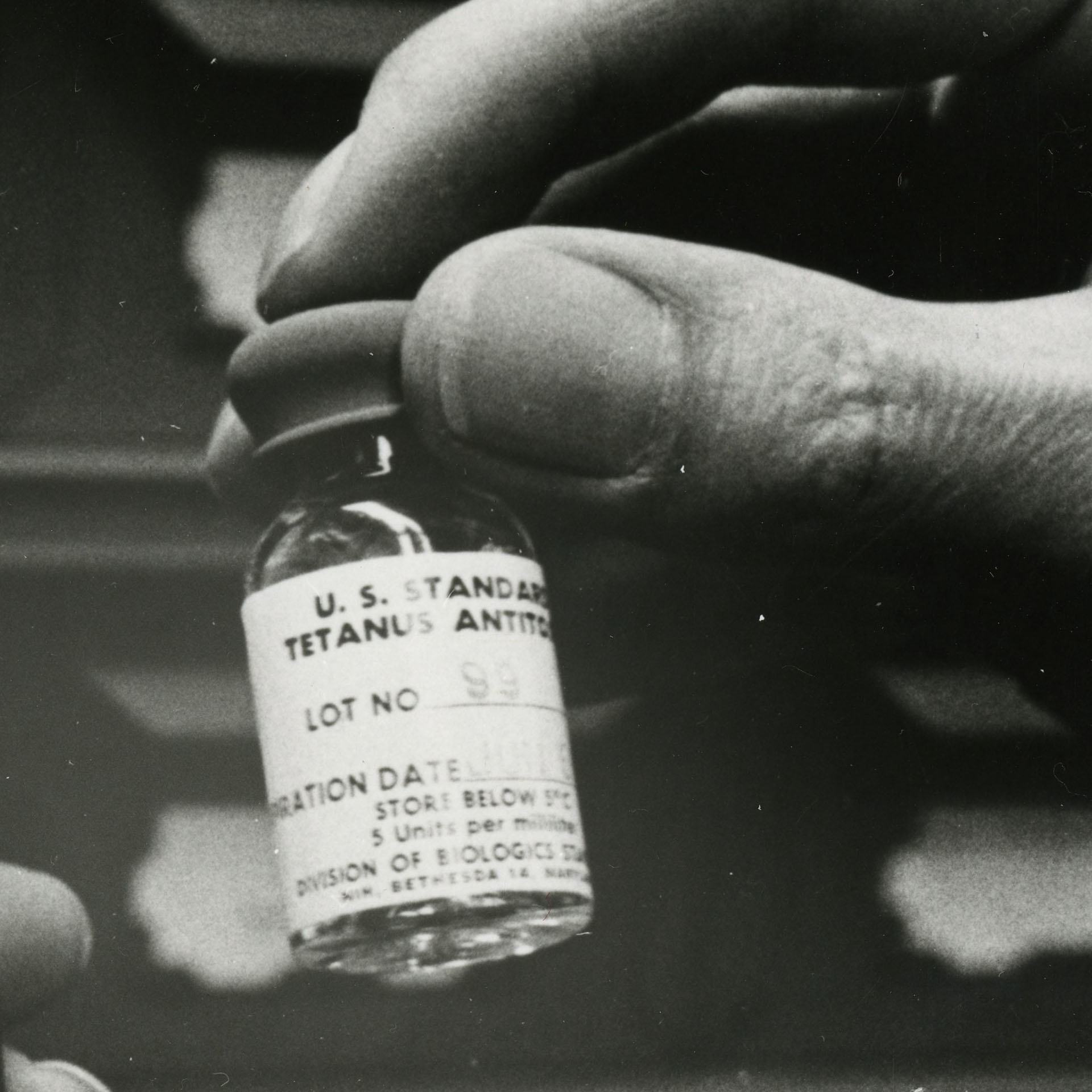 a black and white photo of a vial of tetanus antitoxin
