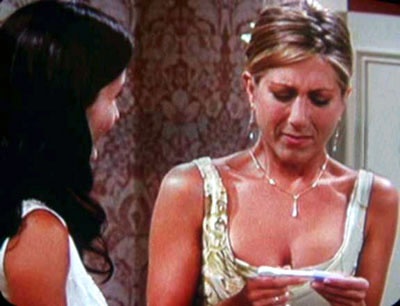 Rachel stares at her positive pregnancy test as her friend Monica looks on (Friends, 2001)