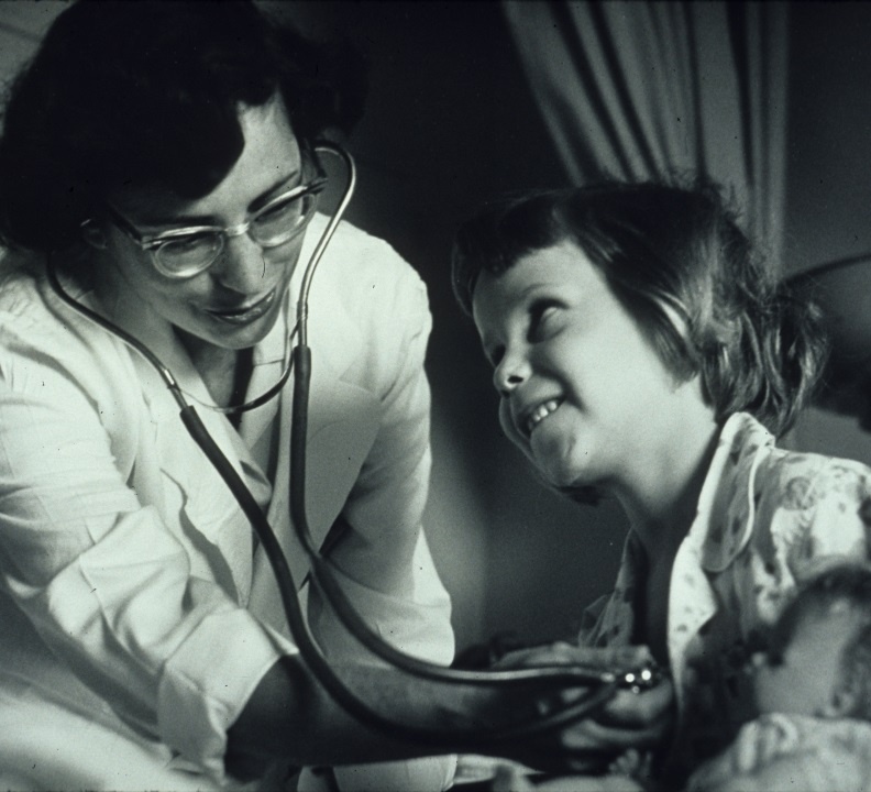 Doctor listening to a young girl's chest using a stethoscope