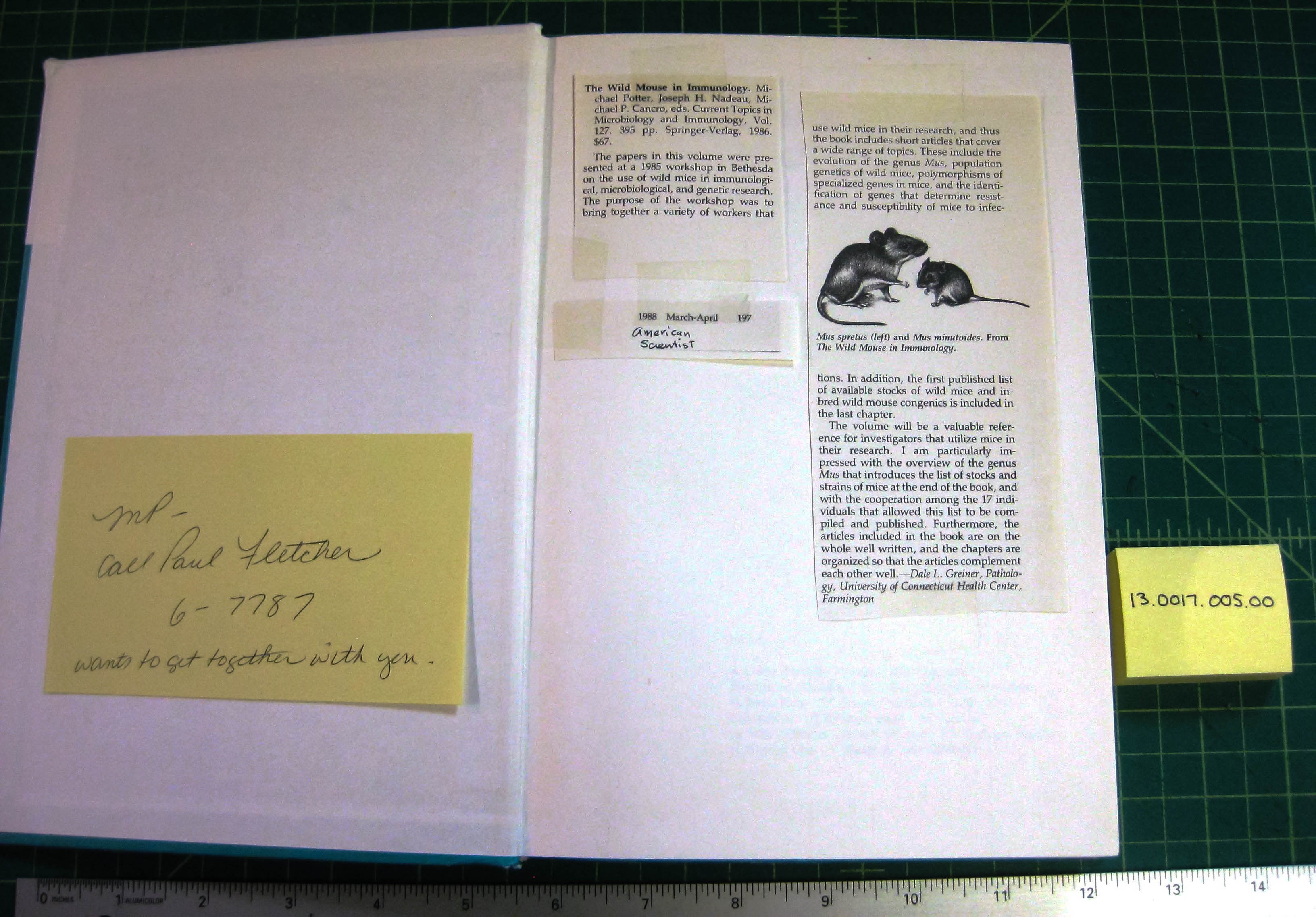 Inside page of book with notes and article clippings taped to inside