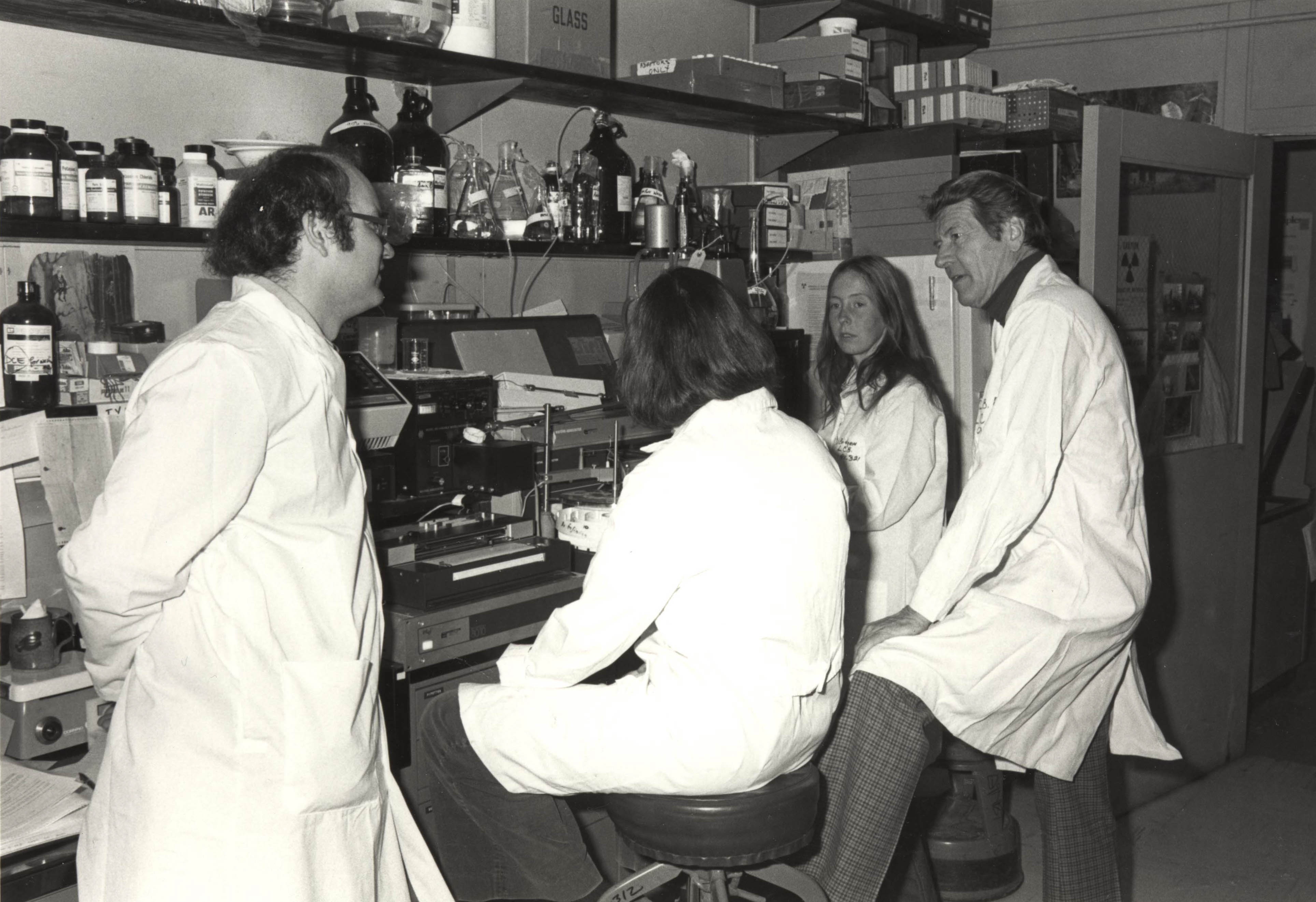 Christian Anfinsen talks with young scientists in his laboratory