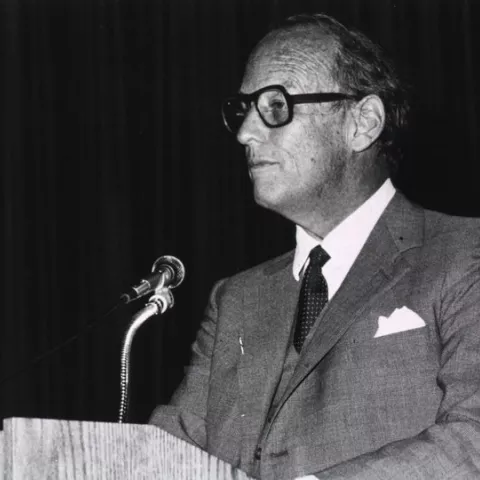 Fredrickson, Donald S is standing behind podium